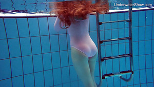 Long haired Simonna is ready to expose her natural pale tits underwater