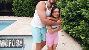 Petite girl and huge man playing naughty by the pool